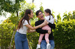 © atitaph - Asian family A bright and cute daughter is relaxing while her parents take their children. go for a walk on the lawn