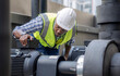 © Basicdog - Engineer inspects a large industrial centrifugal pump.