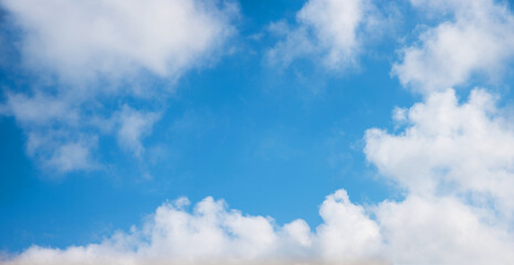 Wall Mural - sky background with fluffy clouds and blue space in the middle