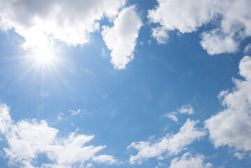 Wall Mural - sky background with fluffy clouds and blue space in the middle, sunrays