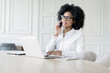 © muse studio - A female secretary with glasses works in the office answers the client's mail, uses a laptop