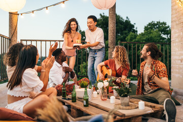 Wall Mural - Friends celebrate a birthday at the rooftop party.