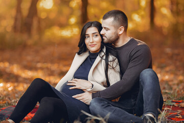 Wall Mural - Beautiful couple spend time in a autumn park