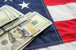 Leinwandbild Motiv Cash on USA flag as a symbol of taxes, inflation, the state budget.