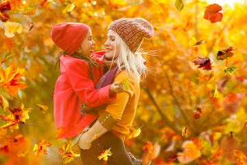 Poster - Mother and her little daughter at beautiful autumn park