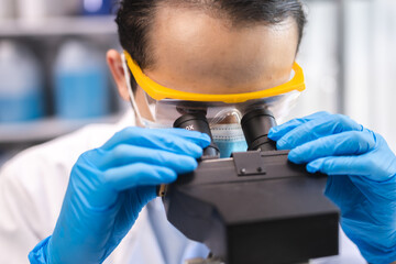 Wall Mural - professional research scientist concentration using microscope in chemistry medicine laboratory, tec