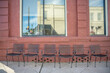 In a charming small town, Inman, S.C., cute iron chairs sitting out on the sidewalk in front of a restaurant with brick exterior, on famous Mill Street.