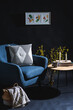 © Syda Productions - interior and home decor concept - close up of blue chair, coffee table and blanket in basket in dark room