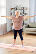 © Syda Productions - sport, fitness and healthy lifestyle concept - smiling senior woman exercising on mat at home