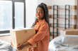 © Syda Productions - moving, people and real estate concept - happy smiling woman holding box at new home