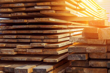 Wooden Boards Are Stacked In A Sawmill Or Carpentry Shop. Sawing Drying And Marketing Of Wood. Industrial Background