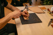© luca loves cameras - Craftsman hammers a leather piece