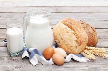 Homemade bread and milk on wooden table