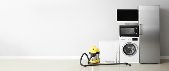 Wall Mural - Different household appliances on light background with space for text