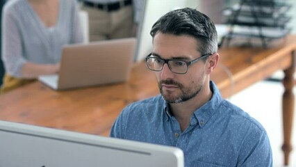 Businessman, work and office of a man working on a computer at his desk in design. People, worker or employee designer being creative as a web developer in a company with technology for success.
