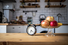 Vintage Alarm Clock And Fresh Fruit On Kitchen Table Intermittent Fasting