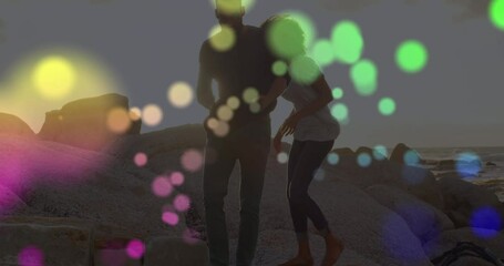 Poster - Animation of light spots over african american couple at beach