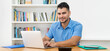 © Daniel Ernst - Laughing hispanic software developer stay at home and work with concentration at computer
