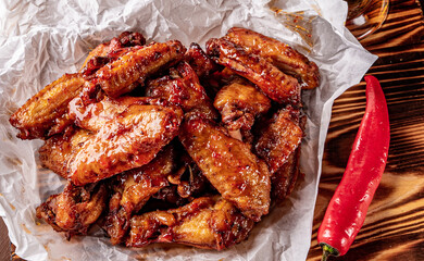 Sticker - fried chicken wings with sweet chili sauce on white paper