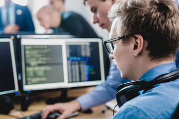 Wall Mural - startup business problem solving. software developers working on desktop computer.