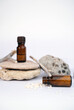 Homeopathy granules with glass bottle on stones and white background