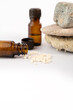 Homeopathic glass bottles with stones on white background. Alternative herbs medicine homeopathy.