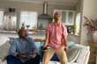 © Wavebreak Media - Happy african american male teenager with his father playing video games