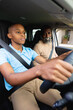 © Wavebreak Media - African american male teenager driving car with his father