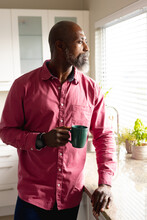 Senior African American Man With Cup Of Coffee Thinking