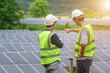 © เลิศลักษณ์ ทิพชัย - Two Asian male engineering teams are about to install solar panels. At the solar power generating station Asian engineering team ordered and installed solar cells