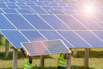 a team of two men install solar panels. work on installing solar panels at a solar power generating 