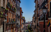 Exterior View Of Beautiful Historical Buildings In Madrid, Spain, Europe. Colorful Mediterranean Urban Street In The Former Jewish Quarter, Lavapiés, Embajadores Neighborhood Of The Spanish Capital.