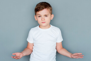 Wall Mural - Closeup portrait of dumb clueless confused boy, arms out asking what's the problem who cares so what, I don't know. Negative human emotion facial expression