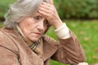 © aletia2011 - sad, thoughtful  senior woman with headache  in  park