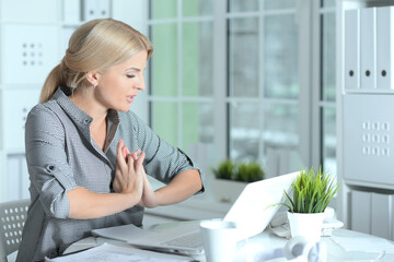 Beautiful smiling businesswoman working with laptop at home