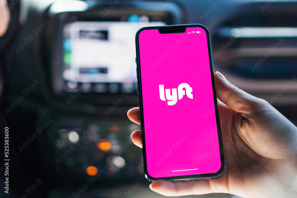 Girl inside car holding smartphone with Lyft app on screen. Rio de Janeiro, RJ, Brazil. August 2022