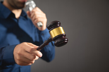 Wall Mural - Caucasian auctioneer holding microphone and gavel.