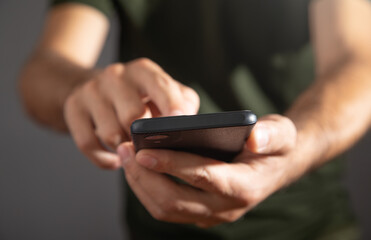 Wall Mural - Caucasian man using smartphone at office.