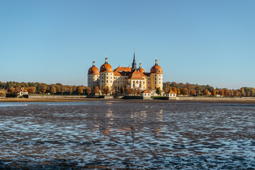 Wall Mural - View of fairy tale Moritzburg Castle in Saxony,Germany.Magnificent baroque palace in middle of large pond and park.Popular location for Czech fairy tale movie Three Nuts for Cinderella.