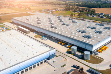 Wall Mural - Aerial view of a warehouse of goods. Aerial view of loading and unloading trucks with goods in warehouse