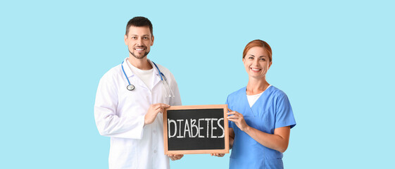 Poster - Doctors holding chalkboard with word DIABETES on light blue background