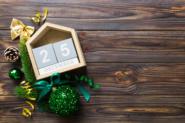 Christmas calendar 25 december. Christmas gift, fir branches, pine cones. Flat lay, top view. New Year decorations on a colored background