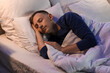 © Pixel-Shot - Handsome young man sleeping in bedroom at night