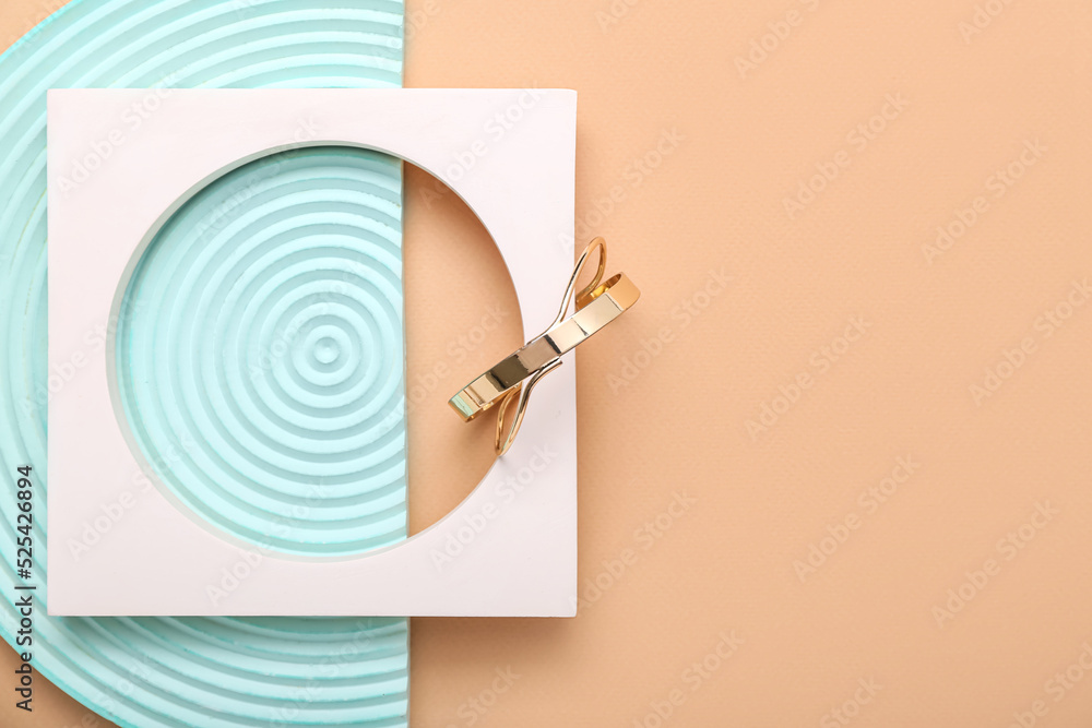 Showcase pedestals and golden bracelets on color background