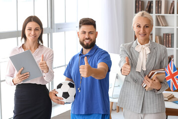 Poster - Teachers showing thumbs-up in school office