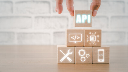 API - Application Programming Interface, Wooden block with VR screen API icon on office desk, Software development tool, modern technology, internet and networking concept.
