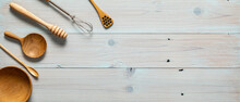 Some Kitchen Tools Are Laid Out On A Wooden Tabletop. Kitchen Props Background. Fork And Spoon