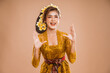 © Odua Images - beautiful balinese woman with shouting gesture over isolated background