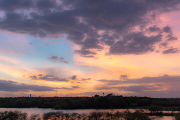 Dramatic pink and purple sunset lake reflection on Woodlawn Lake San Antonio Texas