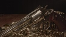 Dolly In Of Beautiful .357 Magnum Revolver Surrounded By Shining Cartridges